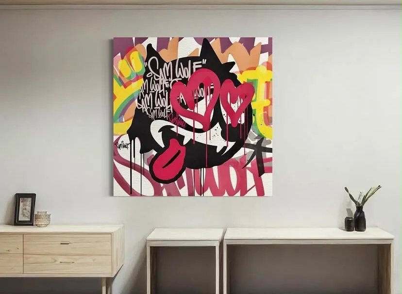 Colourful graffiti-style heart canvas displayed in a room